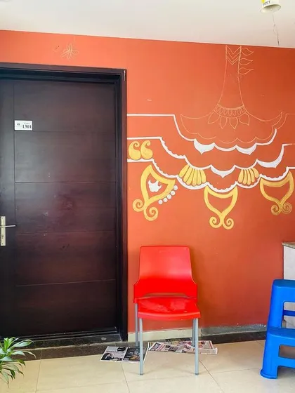 The mural in progress. I started with the main chandelier-like element and then expanded the design outwards. You can see the initial white outlines that guide the golden patterns.