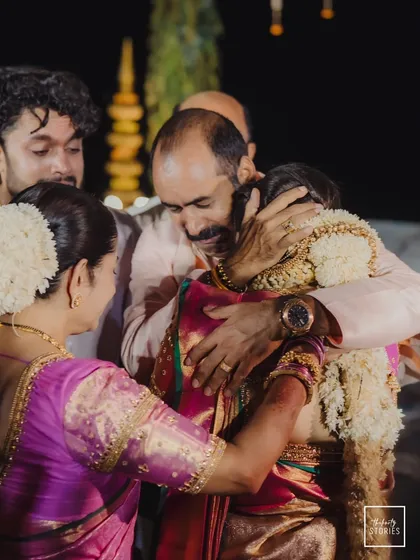 A father's embrace, a moment heavy with love and emotion. We believe in capturing the profound connections and family bonds that are the true heart of any wedding day.