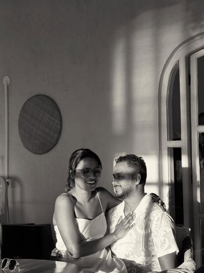 A quiet moment in a beachside cafe. The beautiful play of light and shadow in this black and white photo creates a soft, intimate, and timeless portrait.