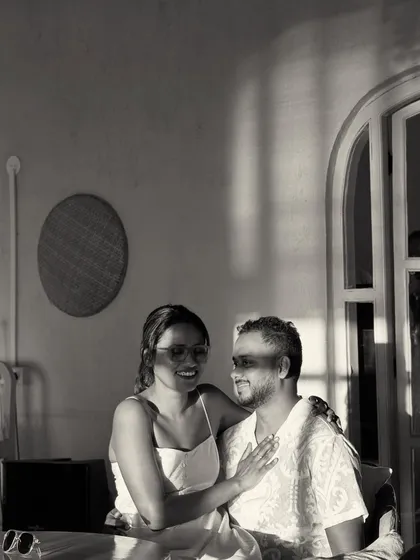 A quiet moment in a beachside cafe. The beautiful play of light and shadow in this black and white photo creates a soft, intimate, and timeless portrait.