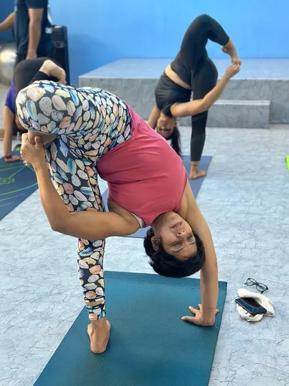 Another student in a challenging standing balance pose. The focus and stability here come from consistent practice and hard work.