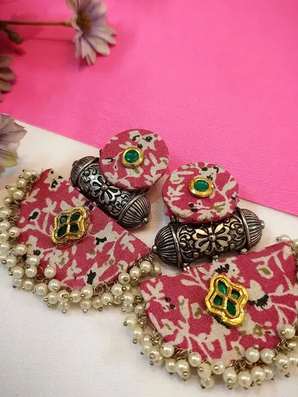 A product shot of the exclusively handcrafted royal pink fabric earrings, perfect for a pop of colour.