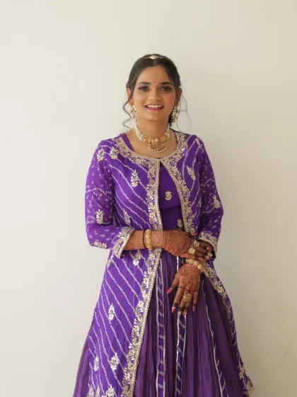 A full-length shot of the bride, looking radiant and happy. Her entire look is a perfect blend of tradition and fun.