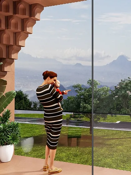 A view from one of the rooms, looking out through the arched balcony to the sacred hills beyond. The design frames the natural beauty of the location.