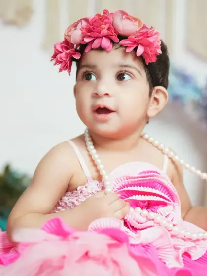 A beautiful baby girl in a pink tutu, surrounded by flowers. This whimsical setup is perfect for a dreamy and feminine portrait.