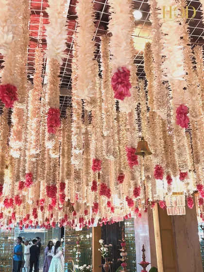 A stunning view of the floral ceiling, with hanging bells and chandeliers interspersed among the flowers, adding a touch of sparkle and sound.