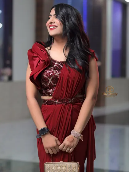 A beautiful full-length portrait of the bride's sister in her elegant red reception outfit.