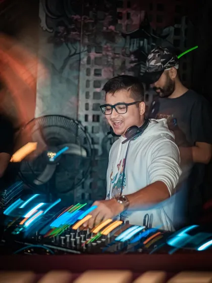 Another dynamic shot with light trails, capturing the fast-paced nature of live DJing.