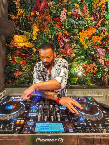 Letting the good vibes roll from behind the decks. This shot captures me in my element at a beautifully decorated venue.