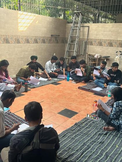 Fellows sit together, studying training materials. Our curriculum is comprehensive, covering everything from music pedagogy to social-emotional learning and classroom management.