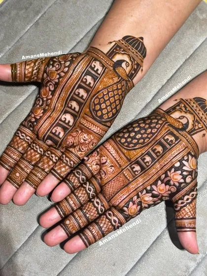 A matching pair of palm designs featuring peacocks inside traditional jharokha windows and rows of elephants, creating a symmetrical and classic look.