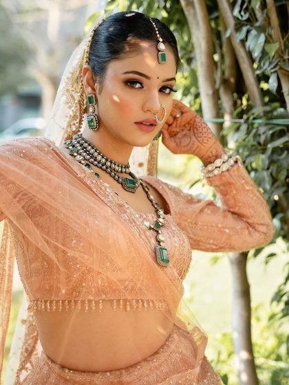 A soft nude makeup look paired with sultry smokey eyes. This is a perfect blend of subtlety and sophistication, ideal for an editorial or bridal shoot.