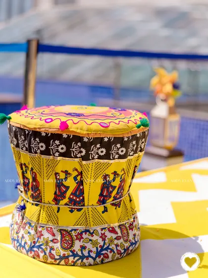 A traditional drum decorated with colorful Indian fabrics, adding a touch of folk art and culture to the Haldi event.