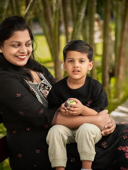 A mother and son share a quiet moment on a park bench. These calm, connected portraits are just as important as the playful ones.