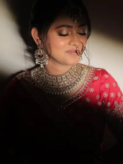 An artistic, moody shot of the bride, highlighting the contours of her face and her stunning jewelry.