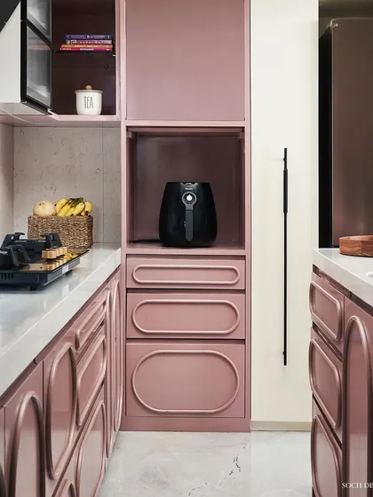 The kitchen from the Whimsical House, where I used a distinctive dusty rose color for the cabinetry. The design features custom rounded and fluted details, demonstrating how functional spaces can also be expressive and full of personality.