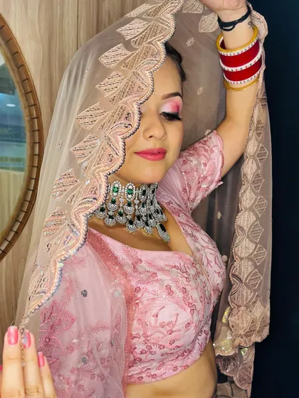 This pose with the veil showcases the elegant embroidery on the dupatta and the bride's confident posture.