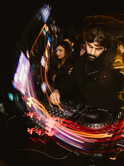 A creative, light-streaked photo that captures the hypnotic, swirling energy of a late-night set. This is what my music feels like.