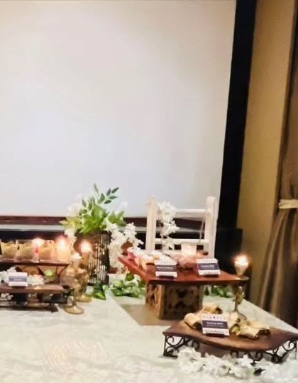 A side view of the Diwali party buffet, showcasing the layered presentation and floral details. Every angle is considered to ensure the setup is visually appealing.