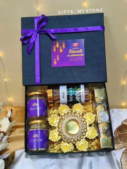 Our premium black corporate hamper, tied with a custom-branded ribbon for M.S. Corporation. It’s filled with dry fruits, incense, chocolates, and a diya.