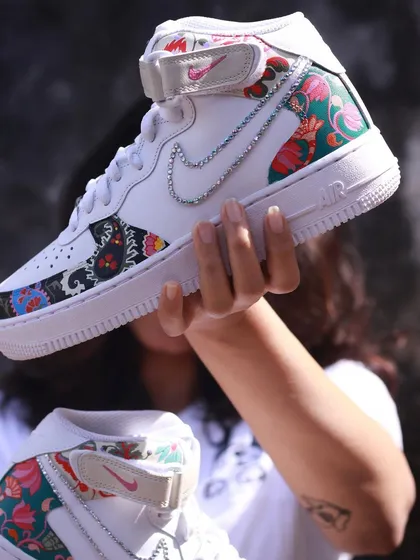 I call these my 'Jaipuri' kicks. This was a fun fusion project, mixing traditional Indian and Persian floral prints with the modern shape of Nike Air Force 1 Mids. I even added a little bling with a crystal swoosh to make it pop.