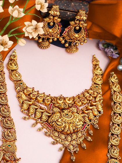 A festive statement set perfect for bridal wear. This image showcases a heavy temple necklace with matching bracelets, crafted with intricate details and designed to be a showstopper.