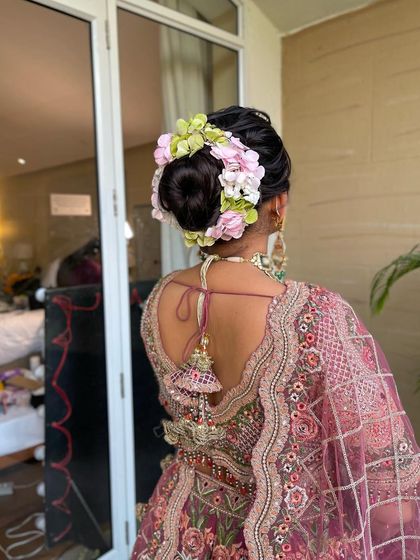 A close up of the floral arrangement in the bride's hair. I use a mix of flower types and colors to create a unique and beautiful bridal bun.