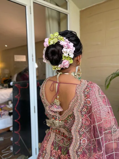 A close up of the floral arrangement in the bride's hair. I use a mix of flower types and colors to create a unique and beautiful bridal bun.