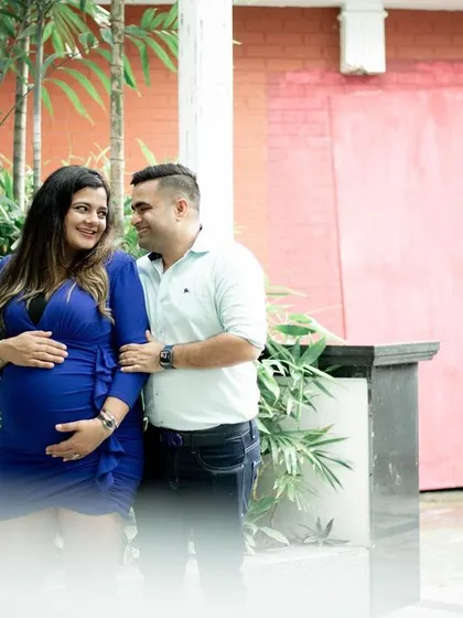A beautiful portrait of the couple framed by lush greenery. Their loving gaze towards each other speaks volumes. It's an honor to capture these milestones for families as they grow.