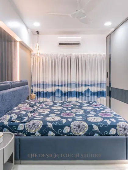 This shot highlights the overall design of the bedroom, with its plush upholstered bed and smart, multifunctional furniture. It's a space crafted for both comfort and elegance.