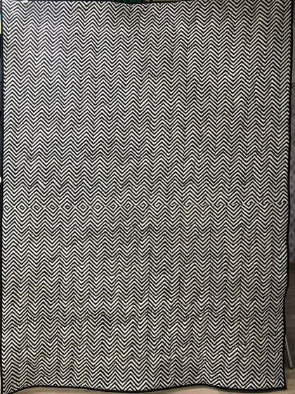 The back of the checkerboard shirt quilt, featuring a bold black-and-white chevron pattern.