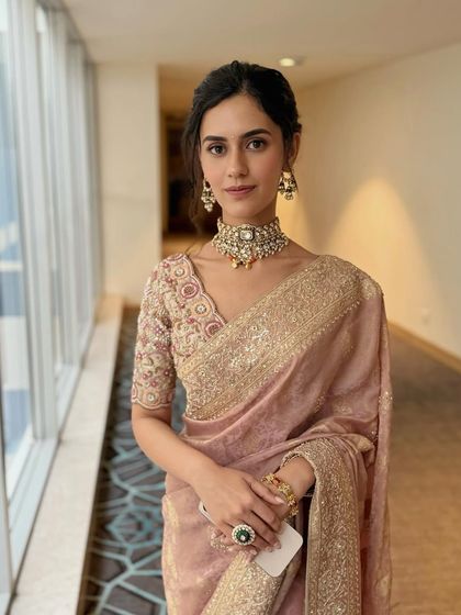 A close-up portrait that highlights the clean, fresh makeup and statement choker.