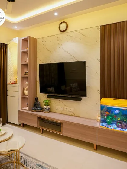 The entertainment center in this living room features a marble-finish back panel and a sleek, low-profile console with an aquarium.