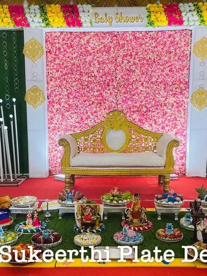 For this baby shower in Karamadai, I arranged 11 German silver plates on a grass floor. The silver adds a touch of elegance and contrasts beautifully with the colorful items.