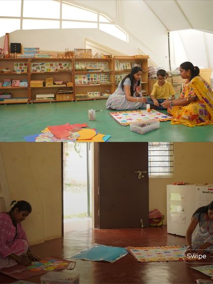 Teachers and students working together on the floor in one of the open learning pods. The architecture is designed to support different modes of learning, moving away from the traditional rigid classroom setup.