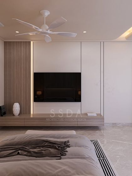 The TV unit in the farmhouse master bedroom is integrated into a clean-lined wall panel of wood and white. This maintains the room's minimal aesthetic while providing functional storage.