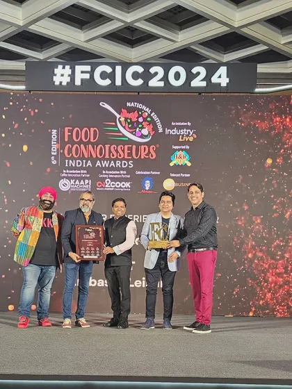 Our team on stage receiving multiple awards at the Food Connoisseurs India Awards 2024.
