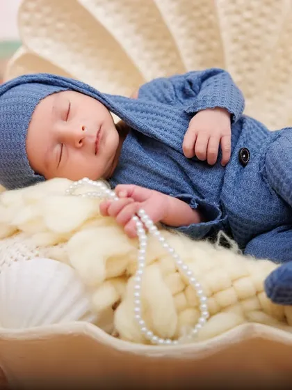 A precious pearl found in an oyster shell. This newborn is peacefully asleep in a shell prop, part of my creative beach and ocean themes.