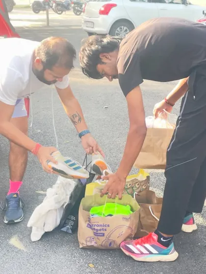 Sorting through donated running shoes and gear for needy players. Every contribution helps us support another athlete on their journey.