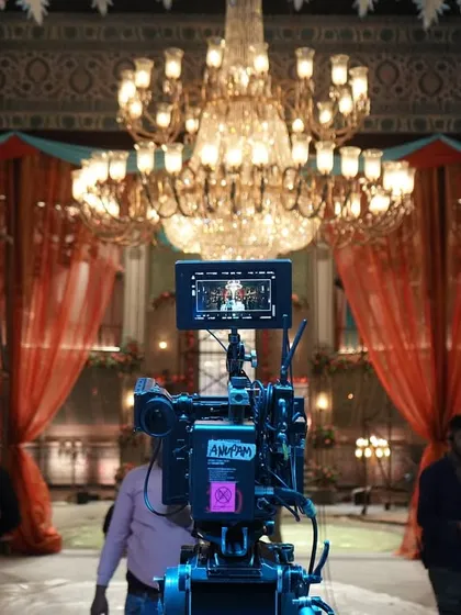 A behind-the-scenes shot from the movie 'Deva', showing the camera and the grand chandelier that was a key part of the set and lighting design.
