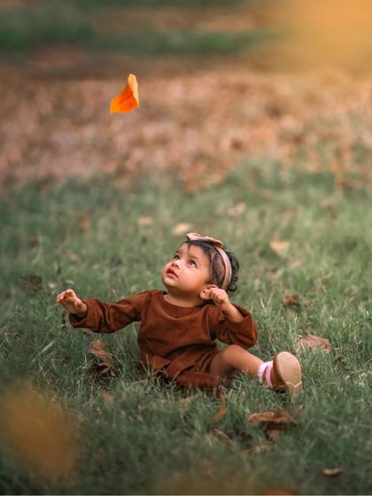 The simple wonder of a baby watching a falling leaf. These are the tiny, magical moments of discovery that I love to capture in my outdoor children's portraits.