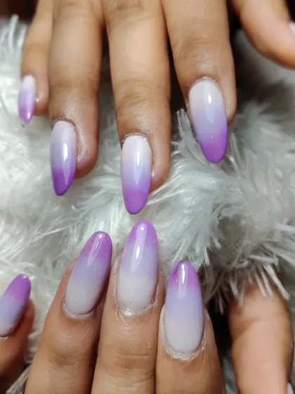 A soft and dreamy purple and white ombre on long, oval-shaped nails. A perfect way to add a pop of color while keeping it elegant.
