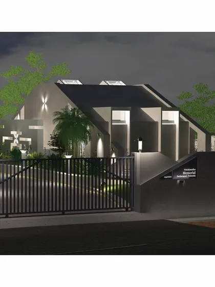 An identical night view of the entrance, showing the gate and the illuminated pathway.