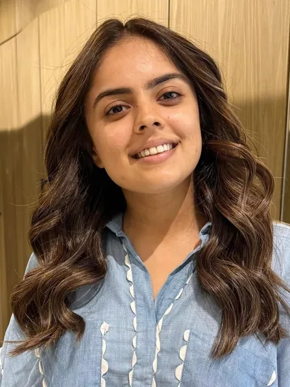 A classic highlight blend for a fresh, summer-ready look. The client's smile shows how happy she is with her new hair.