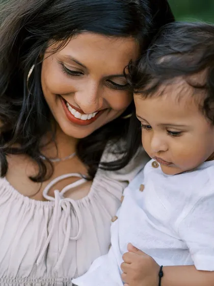 A close-up of a mother and son, both smiling. This photo radiates happiness and the special bond they share.