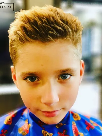 A close-up of a perfectly textured and styled kids' haircut. This modern look is easy to maintain and full of personality, created using professional products suitable for children's hair.
