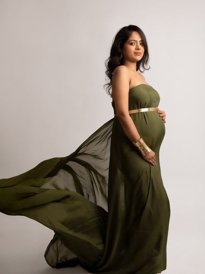 A powerful stance in an olive green gown with gold accessories. This look is strong, regal, and absolutely beautiful.