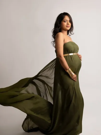 A powerful stance in an olive green gown with gold accessories. This look is strong, regal, and absolutely beautiful.
