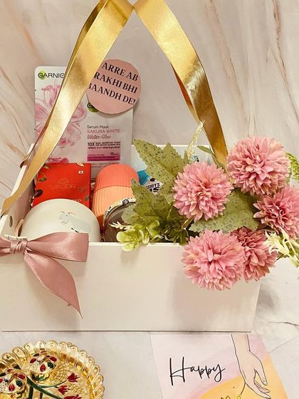 Another look at our lovely basket hamper for a sister, filled with skincare products and decorated with pink flowers. It's a sweet gesture of love and care.