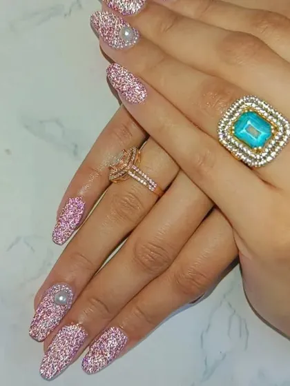 These long, coffin-shaped nails are covered in a gorgeous pink glitter. I added a single pearl on the accent nail for a touch of elegance and dimension.